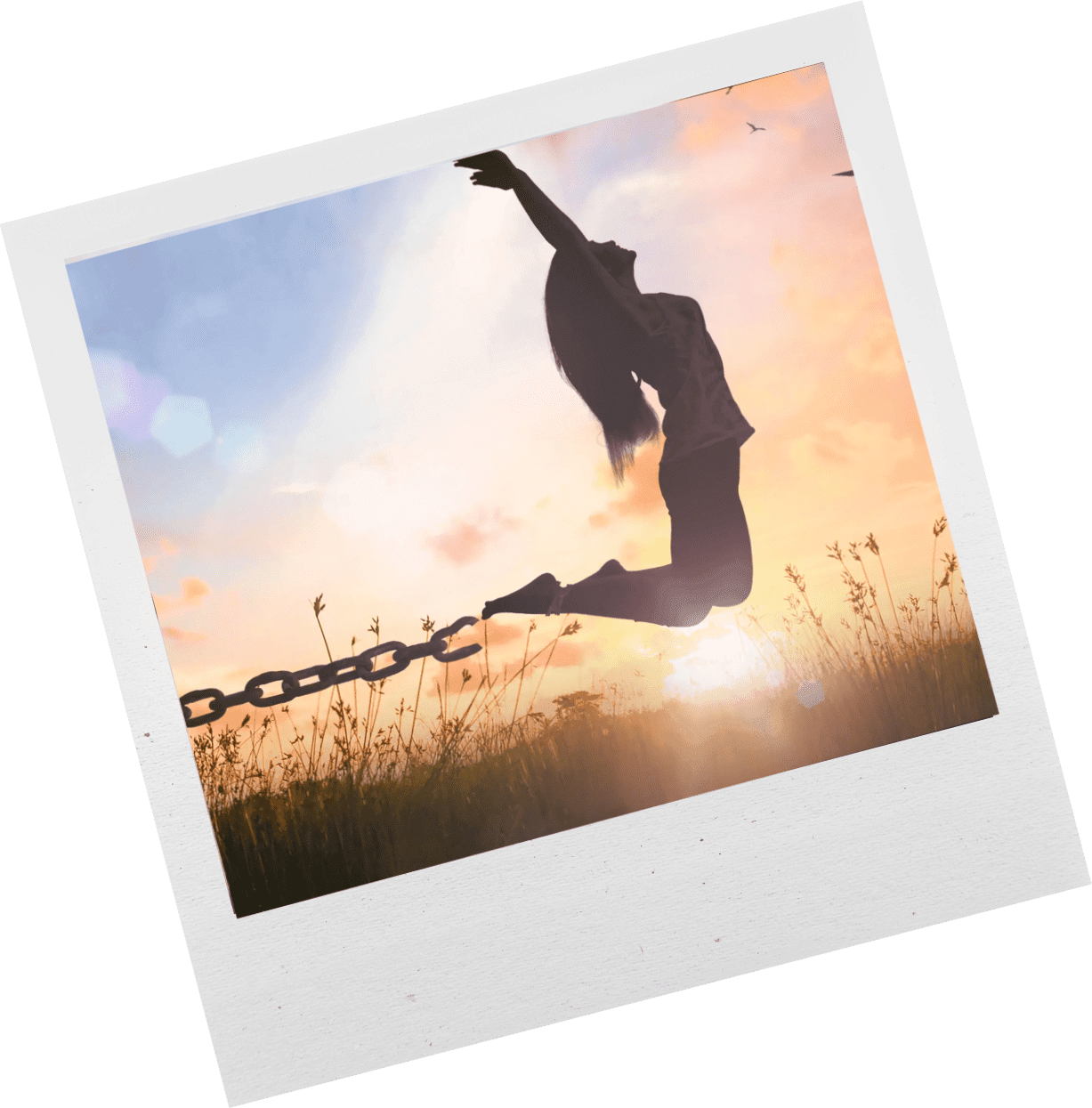 Silhouette of a person breaking free from chains at sunset.