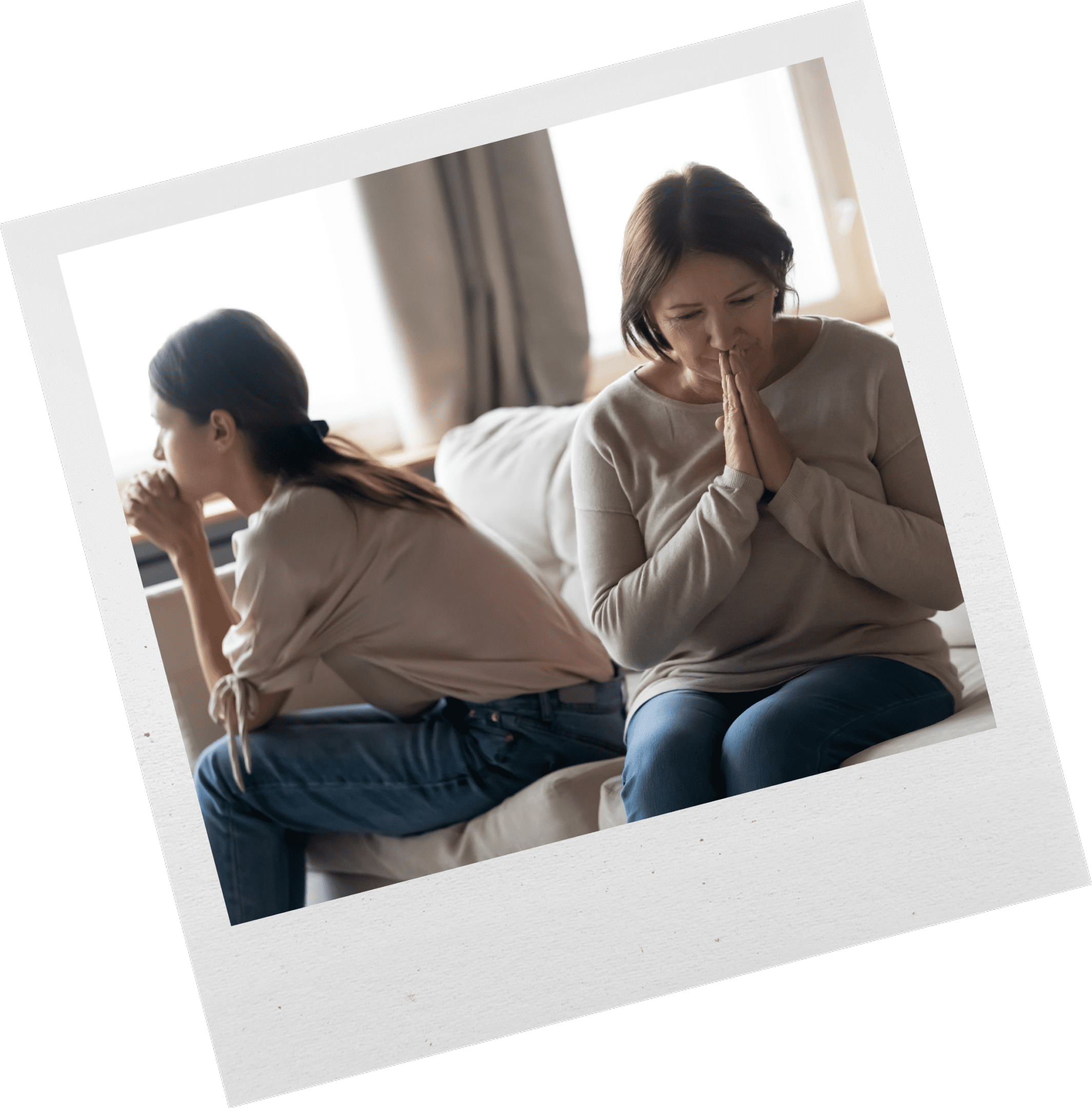 mom and daughter sitting on couch looking away from each other